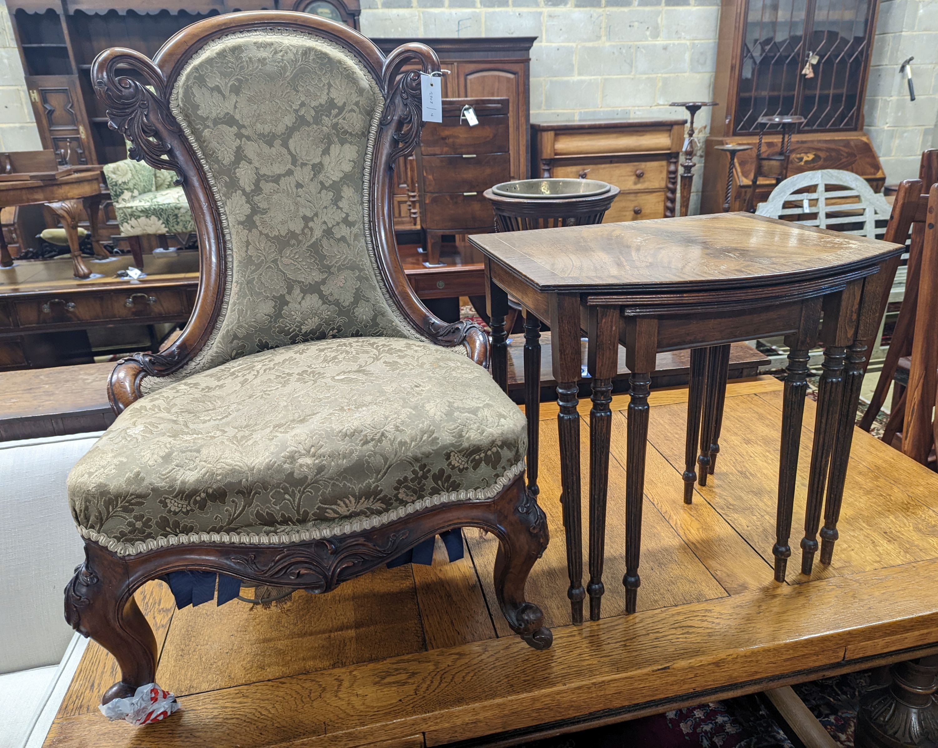 A Victorian walnut nursing chair together with a reproduction nest of tea tables